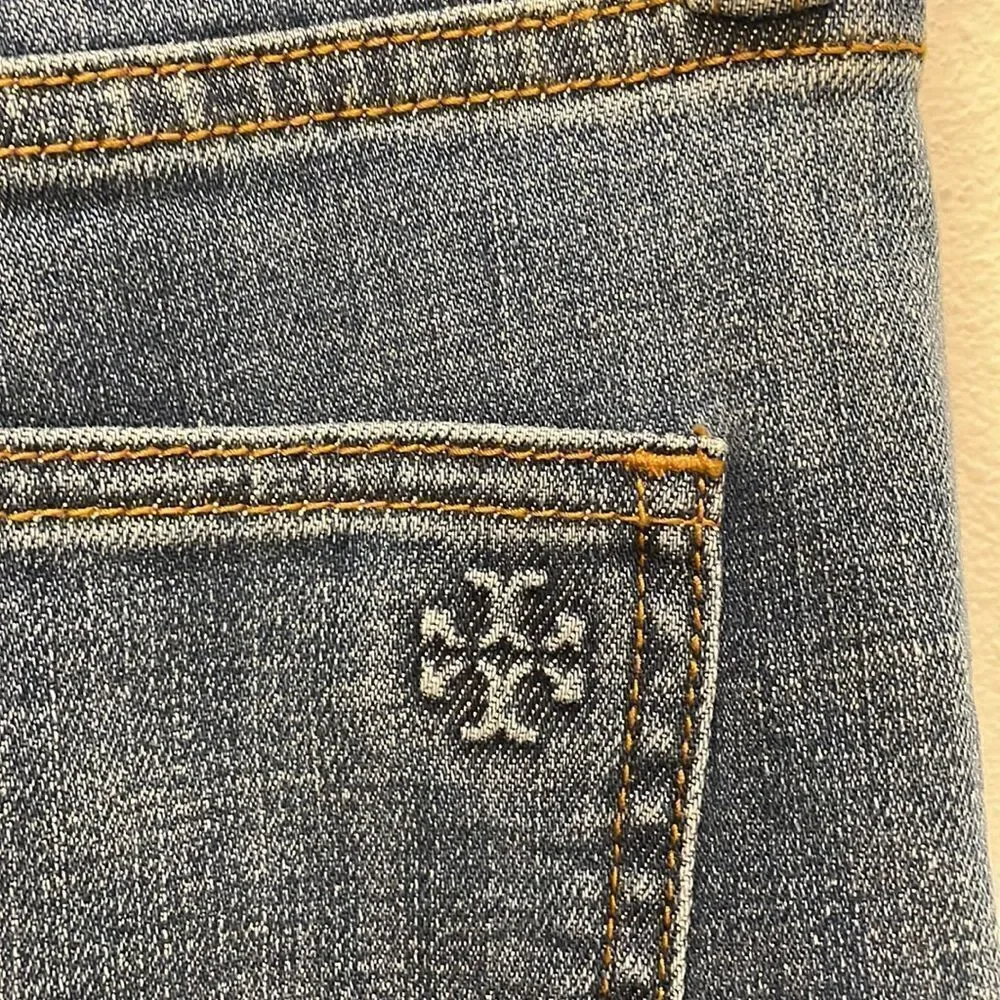 Tory Burch Connor jeans in medium allover stone wash. Cropped. Raffia fringed